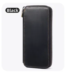 Close-up of black crazy horse leather pen case with yellow contrast stitching and metal zipper