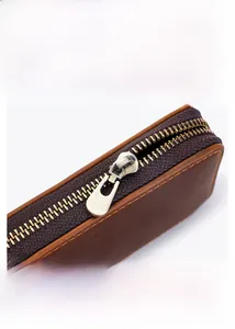 Close-up of durable metal zipper and precision stitching on the leather pen case