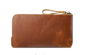 Close-up of crazy horse leather pencil case with yellow stitching and metal zipper