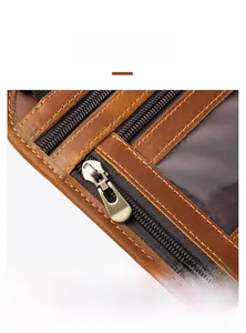 Detail of vintage brown leather passport holder showing metal zipper and durable stitching