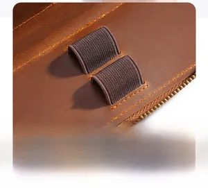 Close-up of elastic pen slots and metal zipper on crazy horse leather pencil pouch