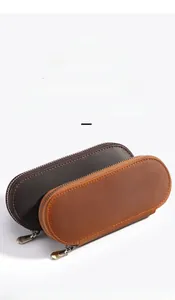 Detail view of crazy horse leather textures and metal zippers on double pen cases