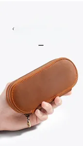 Close-up of handmade crazy horse leather pen case held in hand showing texture