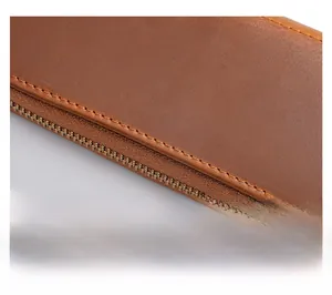 Close-up of brown leather pen case showing precise stitching and durable metal zipper