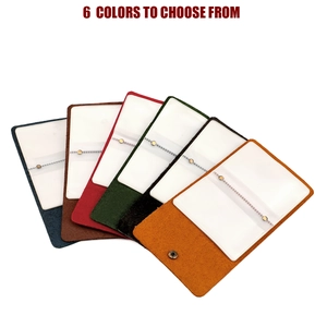 Detail view of colorful leather card holders in six shades with secure snap closure