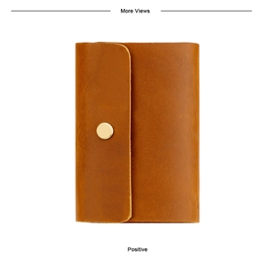 Detailed view of genuine leather credit card holder with metallic snap button closure