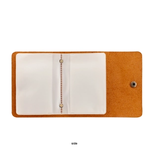 Close-up of brown leather card holder featuring transparent slots and a metal snap button