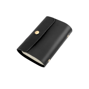 Detailed view of black genuine leather card holder with gold snap button closure