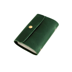 Close-up of dark green genuine leather wallet showing premium grain texture and gold clasp