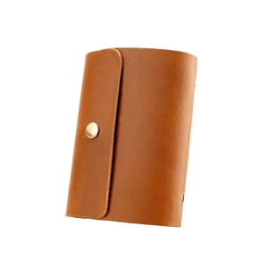 Classic brown leather credit card holder with secure metal snap closure on white background