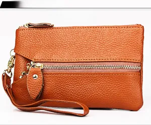 Brown leather coin purse with lychee texture and gold zipper detail with wrist strap