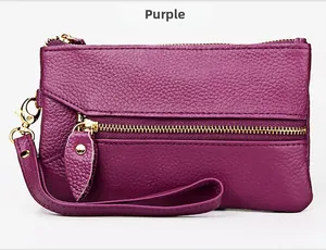 Detail of purple lychee grain leather wallet with gold zipper and wrist strap