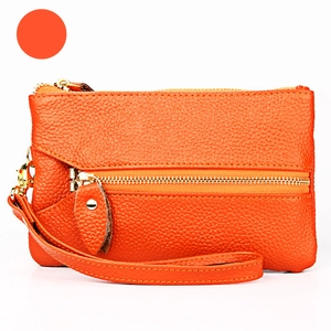 Orange lychee grain leather wristlet with double gold zippers and a functional front pocket