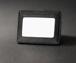 Detail view of black lychee grain leather wallet with a clear ID card window