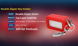 Detail of red genuine leather dual-zipper car key case with metal hook and lychee texture