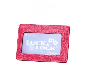 Detail of rose red lychee grain leather wallet with a clear ID window and fine stitching
