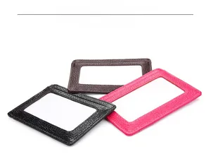 Detail view of leather card holders in black, brown and pink with neat stitching