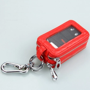 Detail of red crocodile texture leather car key bag with dual zippers and clear window