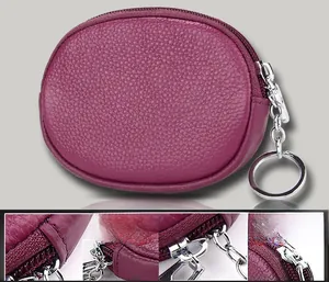 Macro detail of purple pebble leather mini pouch showing stitching and silver metal zipper