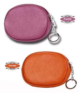 Detailed macro view of purple and orange genuine leather mini wallets with keychains