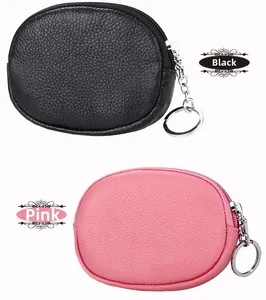 Close-up of pebble leather mini coin purses in black and pink with metal key rings