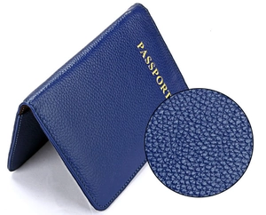 Détail du protège-passeport en cuir bleu foncé avec lettrage jaune et texture