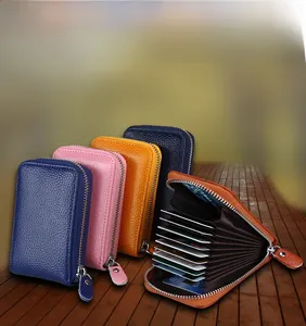 Detail view of leather accordion card holder with multiple slots and metal zipper