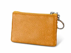 Detail view of yellow genuine leather coin pouch with side metal key ring and zipper