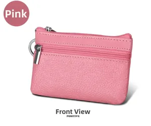 Close-up of pink genuine leather coin purse with double zippers and metal keychain ring