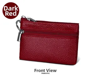 Detail of dark red leather wallet with double zippers and silver key ring attachment