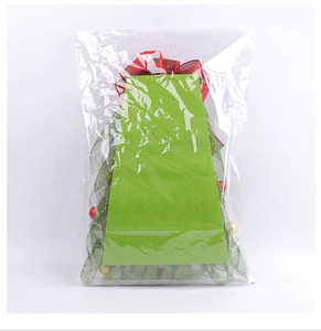 Detail van kerstboomkransset met groen gaasweefsel en feestelijke geruite strik