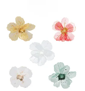 Detail of mesh Christmas flowers with glitter sequins and multi-color layered petals