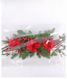Detailed packaging view of Christmas garland with red poinsettia and pine cones
