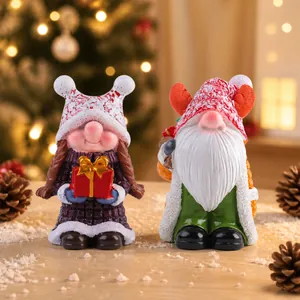 Close-up of resin Christmas gnome figurines with knit-style hats and snowflake details
