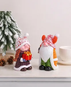 Detailed view of hand-painted resin Christmas gnomes figurines in a cozy holiday setting