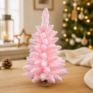 Detailed close-up of pink flocked mini Christmas tree with a rustic burlap base