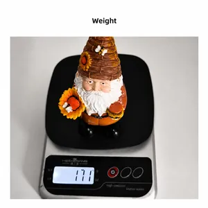 Detail of resin gnome figurine holding sunflower and honey jar weighing 171 grams