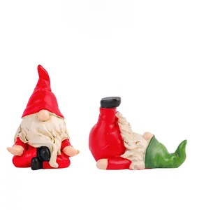 Detail of red and green yoga gnomes in meditation and handstand poses for Christmas decor