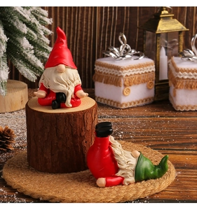 Close-up of Christmas yoga gnomes ornaments on festive wooden table with pine cones