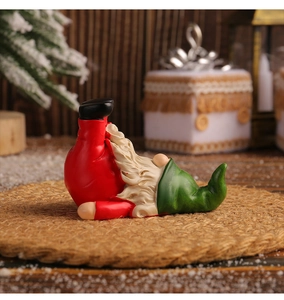 Macro shot of a Christmas gnome figurine in an upside down pose on a rustic mat