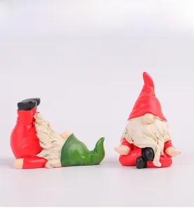 Close-up of handmade Christmas gnomes in creative yoga and meditation poses