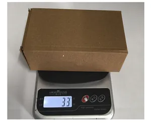 Vue macro d'un emballage en carton ondulé marron montrant un poids de 33g sur une balance