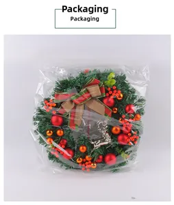 Red berry and gold bauble Christmas wreath detail in clear protective packaging