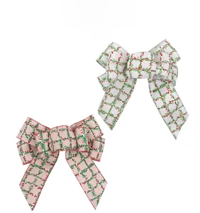 Detail of Christmas burlap bows with red and green holly leaf patterns for DIY decor