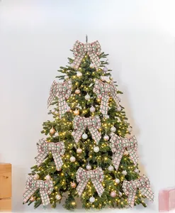 Christmas burlap bow with red and green plaid pattern on a decorated tree