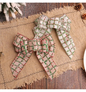 Detailed view of rustic burlap Christmas bows with festive pine and red berry patterns