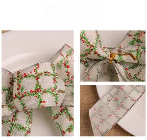 Detail of Christmas burlap bow showing pine needle berry print and silver glitter edges