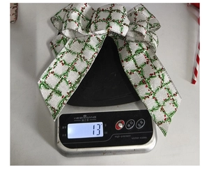 Detailed scale view showing the 13g weight of the white linen Christmas bow ornament