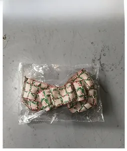 Detail of Christmas burlap bow decoration in red and green pine pattern packaging