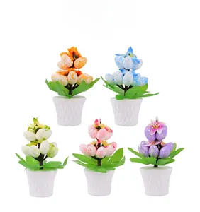 Detailed set of five colorful speckled Easter egg potted plants with green leaves